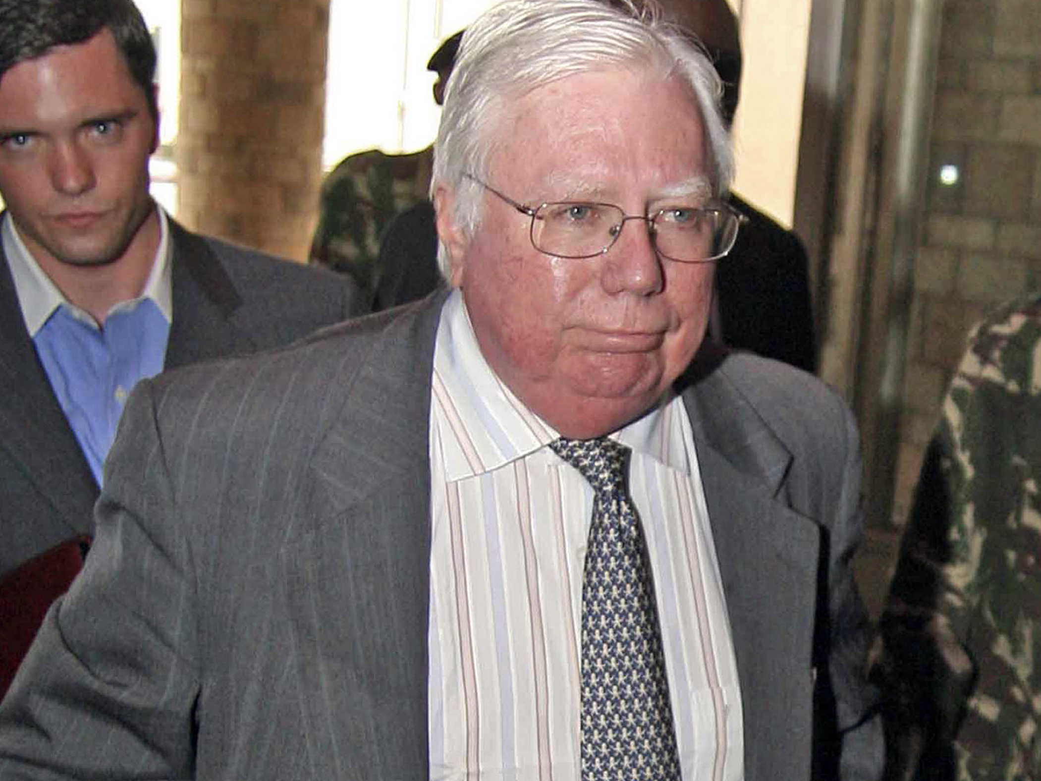 caption: In this Oct. 7, 2008, file photo, Jerome Corsi, right, arrives at the immigration department in Nairobi, Kenya.