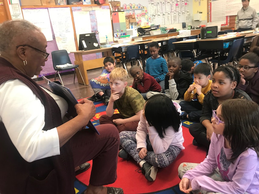 caption: Carrie Richardson reads to students at Lowell Elementary School in Seattle.