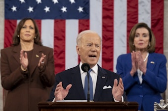 caption: President Biden delivers the State of the Union address as U.S. Vice President Kamala Harris (L) and House Speaker Nancy Pelosi (D-CA) look on last March.
