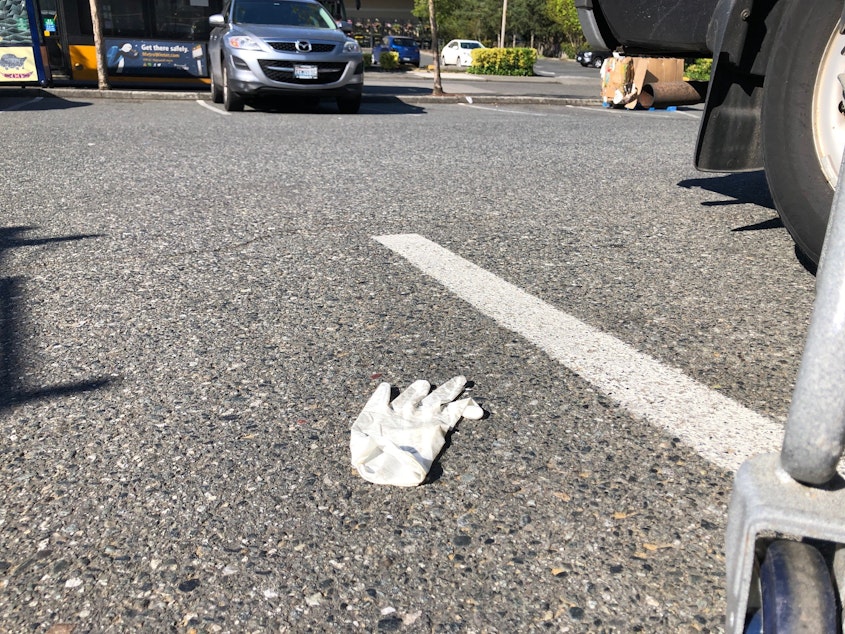 caption: A disposable glove on the ground outside a Seattle grocery store, April 2020. 