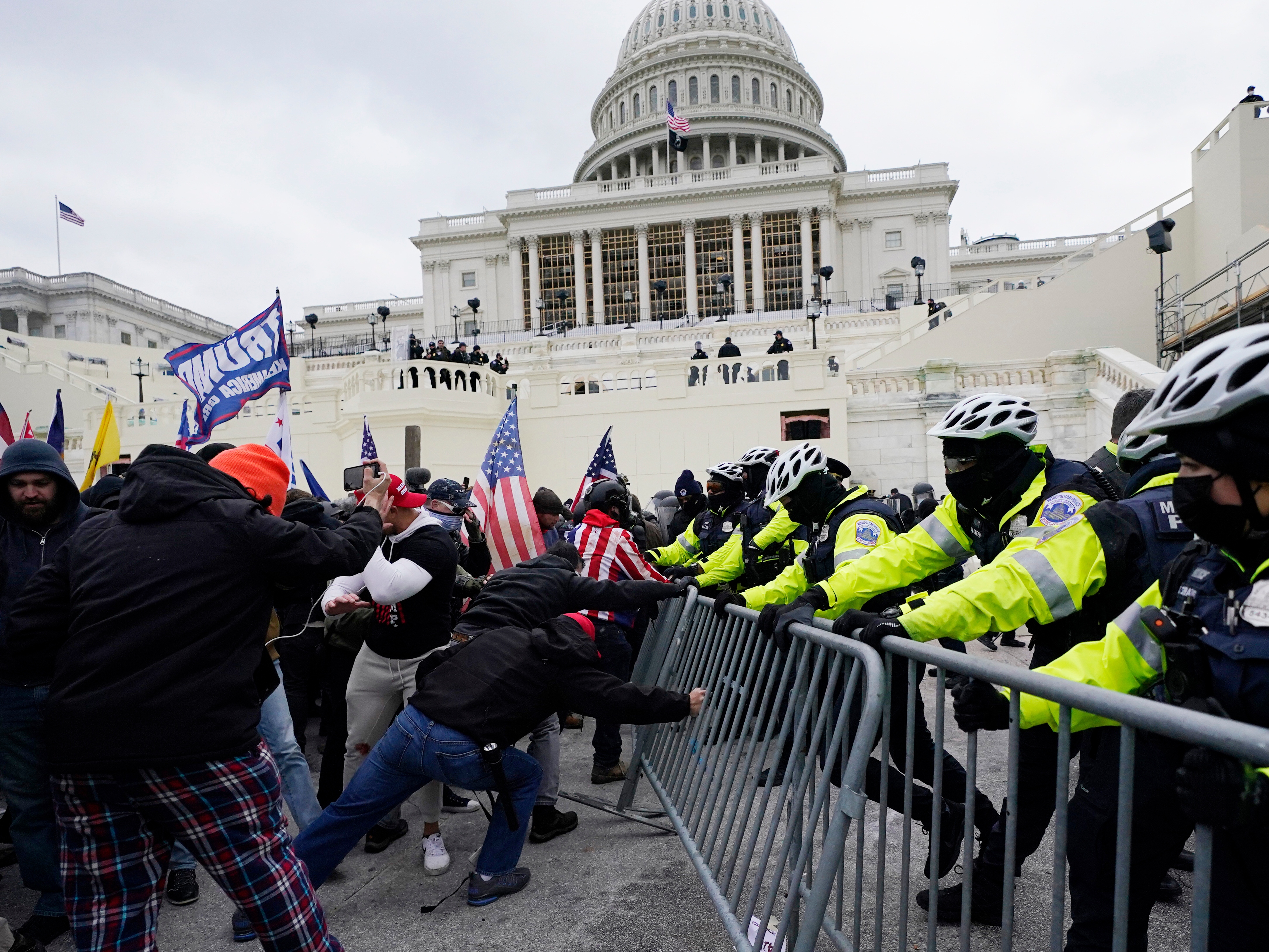 caption: Violent insurrections loyal to President Donald Trump break through a police barrier at the Capitol in Washington on Jan. 6, 2021.