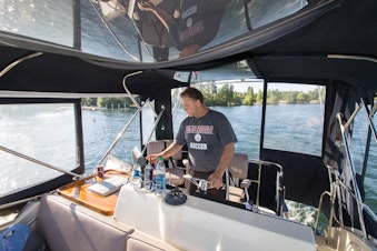 caption: "Nobody takes out the trash on the bottom of Lake Washington," says Mike Racine, captain of "Hat Trick." 