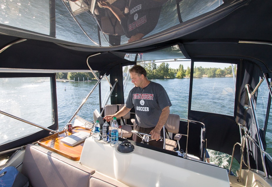 caption: "Nobody takes out the trash on the bottom of Lake Washington," says Mike Racine, captain of "Hat Trick."