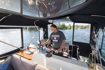 caption: "Nobody takes out the trash on the bottom of Lake Washington," says Mike Racine, captain of "Hat Trick." 