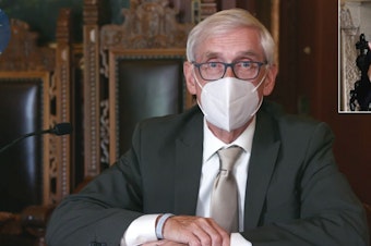 caption: A Wisconsin judge upheld Gov. Tony Evers' order mandating that face coverings be worn in enclosed spaces statewide, save for a few exceptions. A conservative legal group challenged the measure, arguing that Evers overstepped his authority in issuing successive emergency orders.
