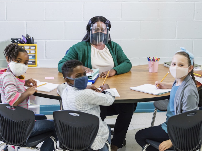 caption: When children and teachers wear masks in class, studies show it limits the spread of the coronavirus.