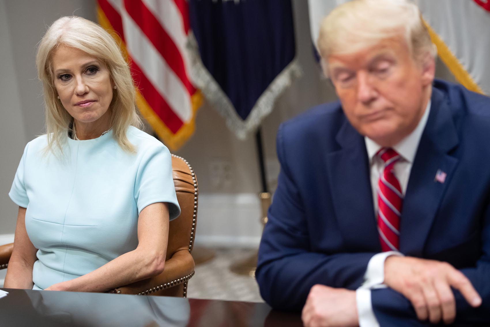 caption: U.S. President Donald Trump sits alongside Kellyanne Conway (left), counselor to the president, during a meeting on the opioid epidemic in the Roosevelt Room of the White House in Washington, June 12, 2019. (Saul Loeb/AFP/Getty Images)