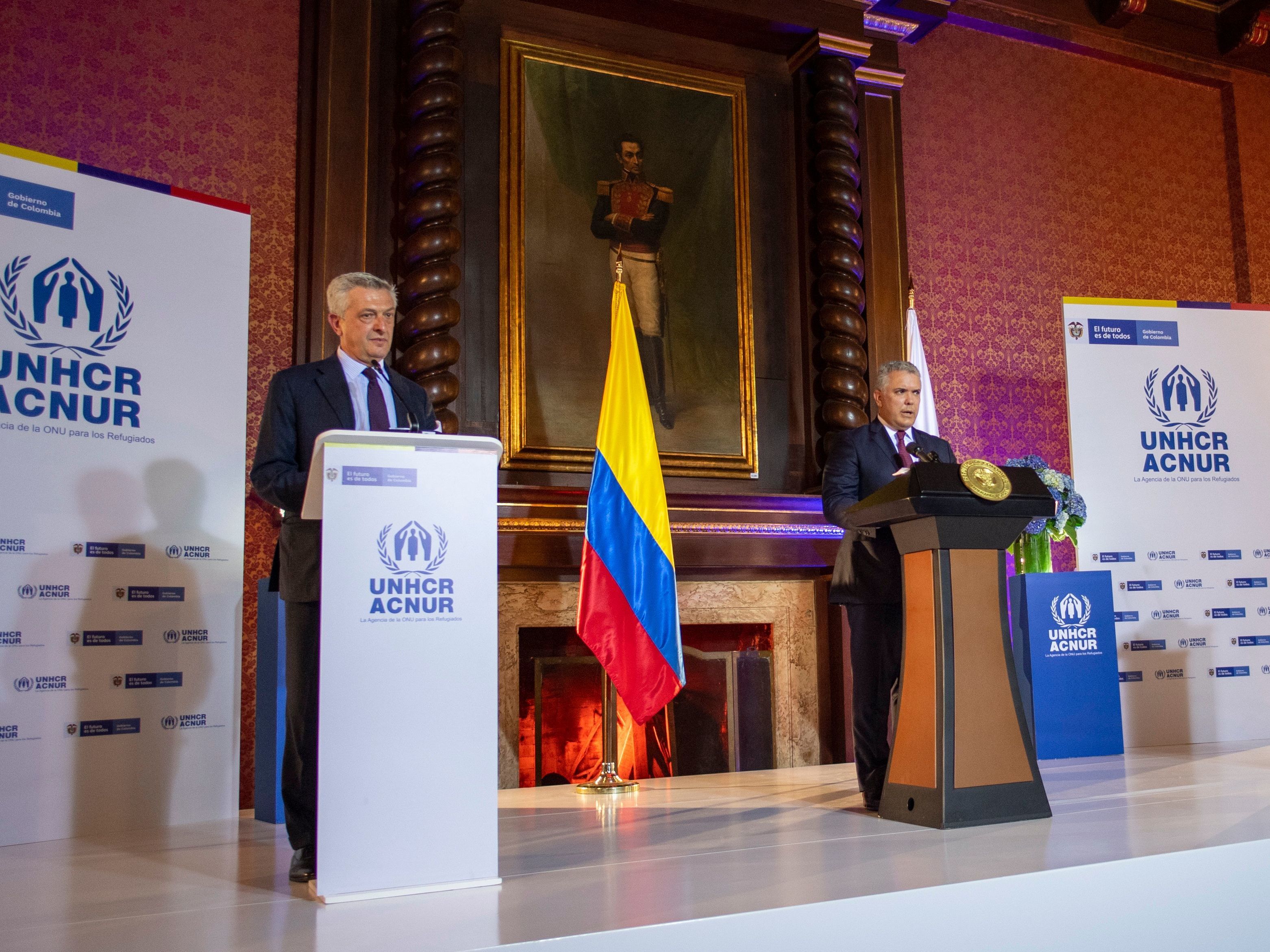 caption: Colombian President Ivan Duque (right) and UN High Commissioner for Refugees Italian Filippo Grandi (left) held a briefing in Bogota on Feb. 8 to announce the temporary regularization of almost one million undocumented Venezuelans living in Colombia.