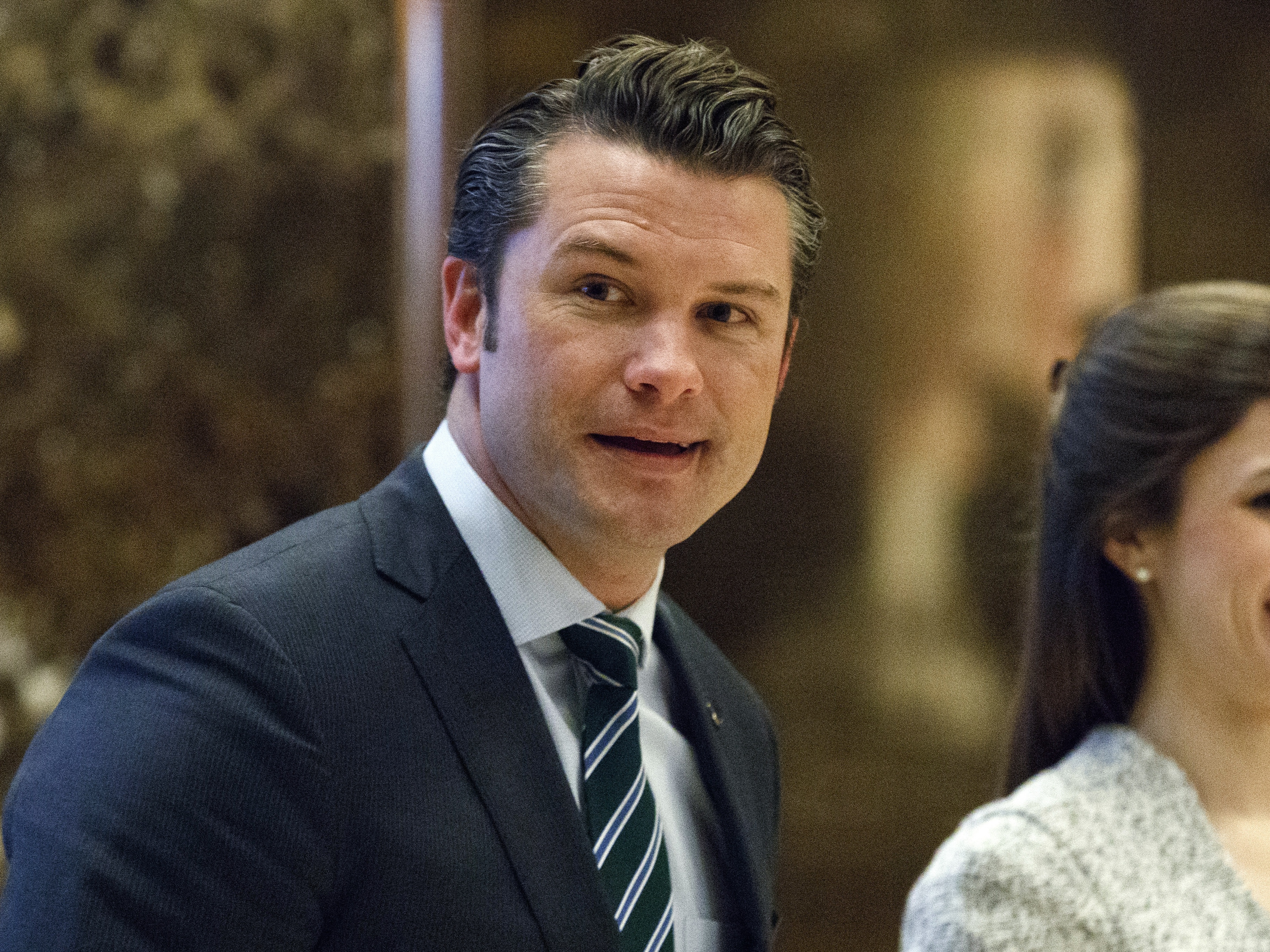 caption: Pete Hegseth walks to an elevator for a meeting with President-elect Donald Trump at Trump Tower in New York in 2016.