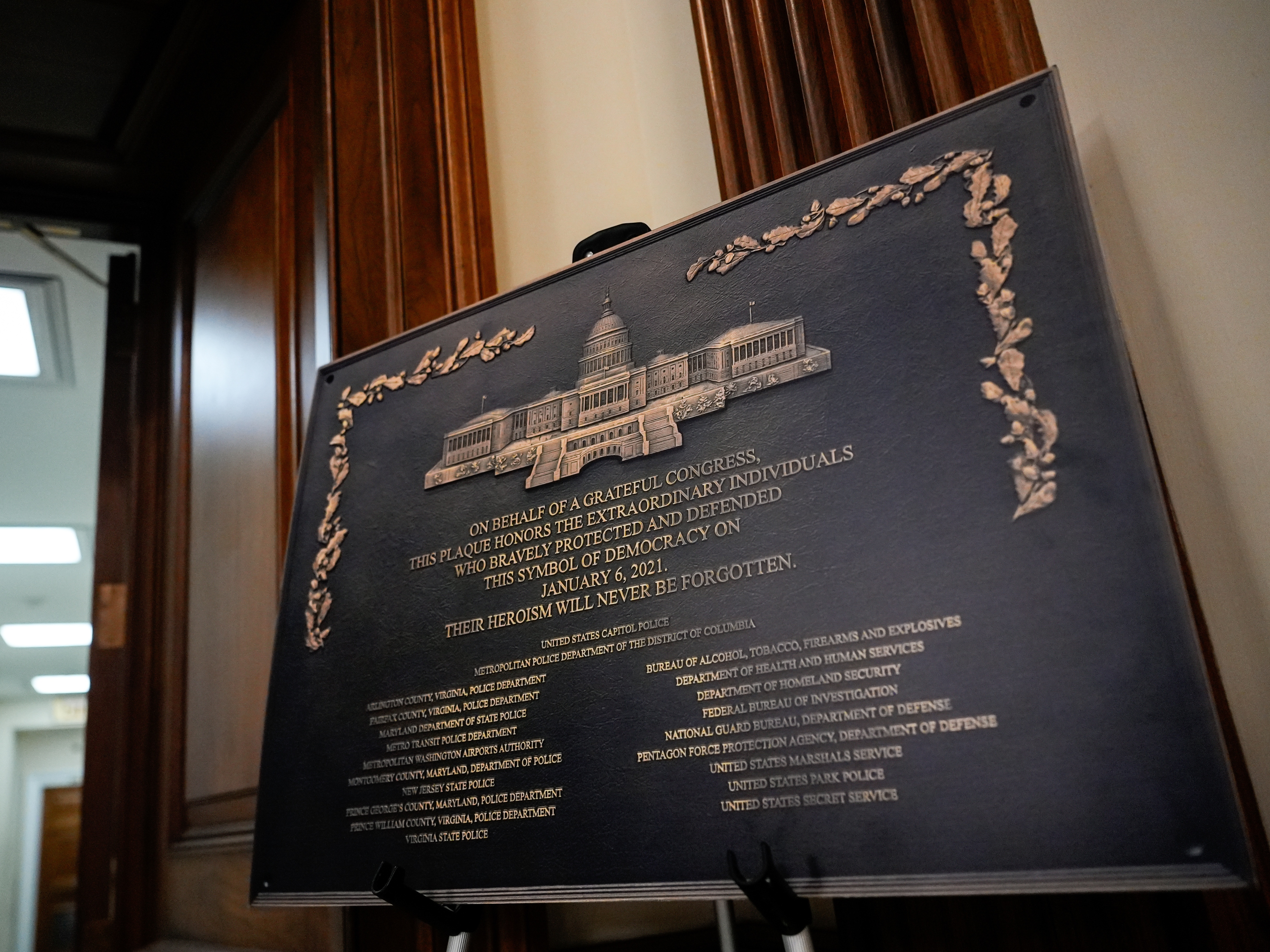 caption: A replica plaque commemorating the Jan. 6, 2021 Capitol riot stands outside the office of House Minority Leader Hakeem Jeffries, D-N.Y, Tuesday, Dec. 30, 2025, at the U.S. Capitol in Washington.