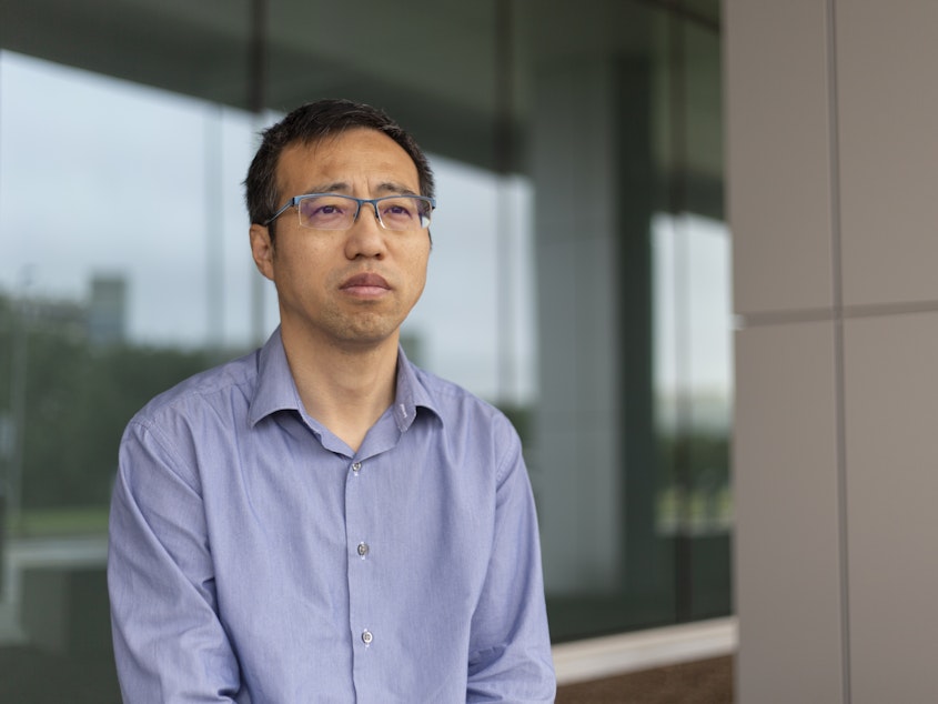 caption: In severe pain and uncertain of its cause, Tieqiao Zhang of Dallas says he didn’t want to wait for an appointment with his regular doctor, but he also wasn’t sure if he needed emergency care. He visited a clinic on the campus of Dallas’ largest public hospital — and was charged 10 times what he expected. 