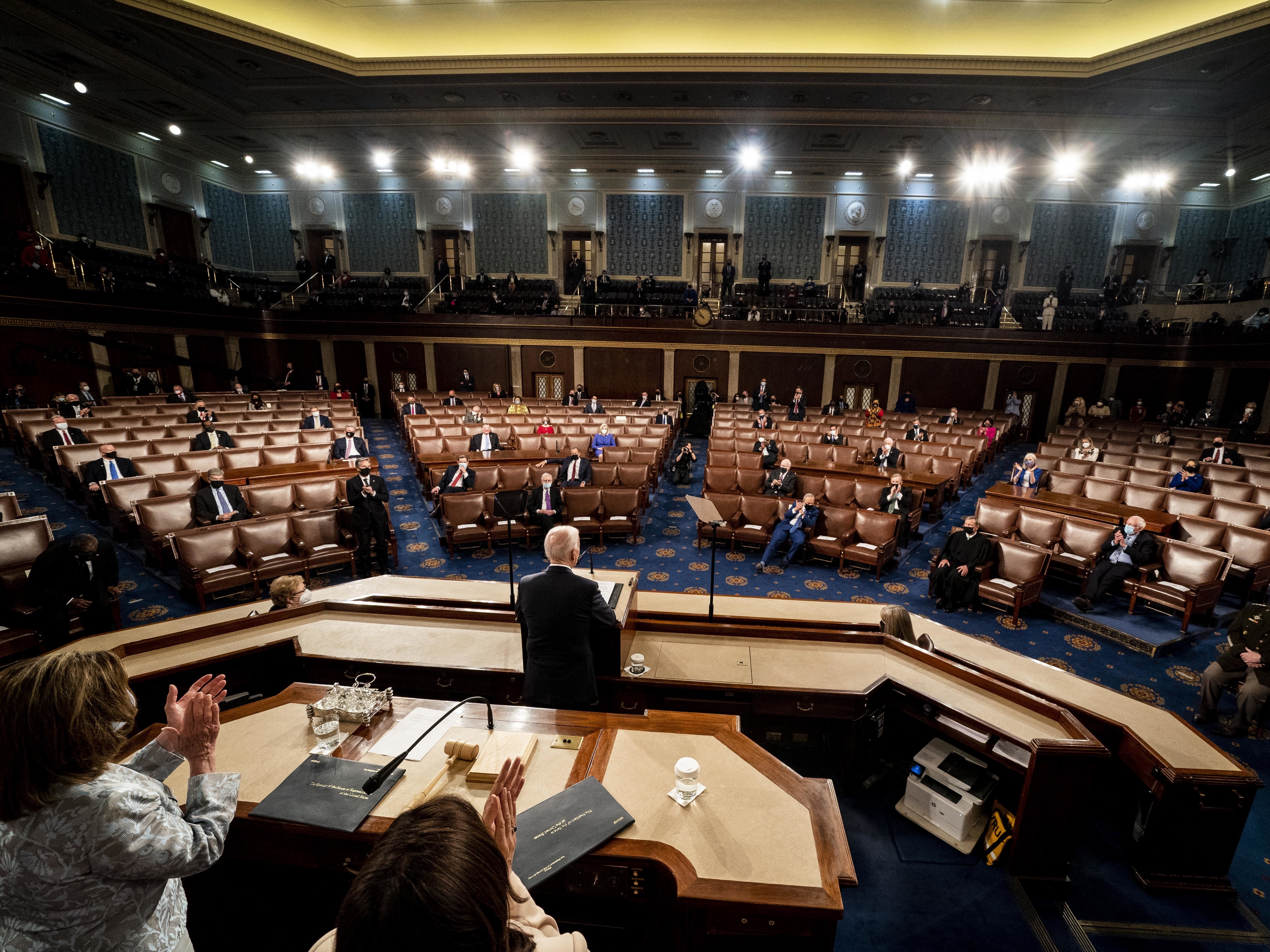 caption: President Biden's State of the Union speech Tuesday will be his first since becoming president. But in April 2021, he addressed a joint session of Congress, with House Speaker Nancy Pelosi and Vice President Harris behind him on the dais.