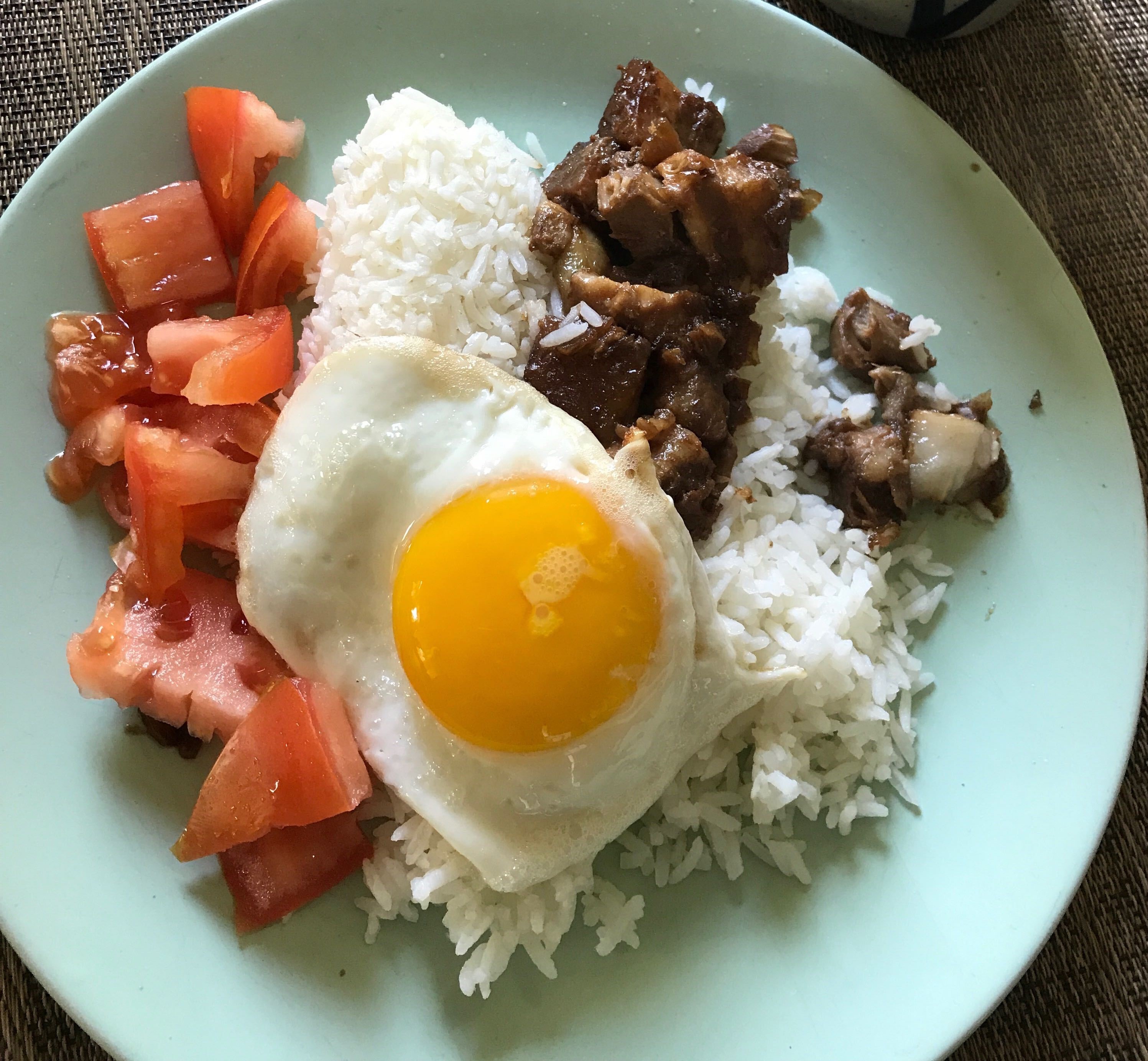 caption: Gracie Santos, front of house manager for the Seattle restaurant Archipelago, has been cooking a lot during the pandemic. This pork adobo is a classic Filipino dish.