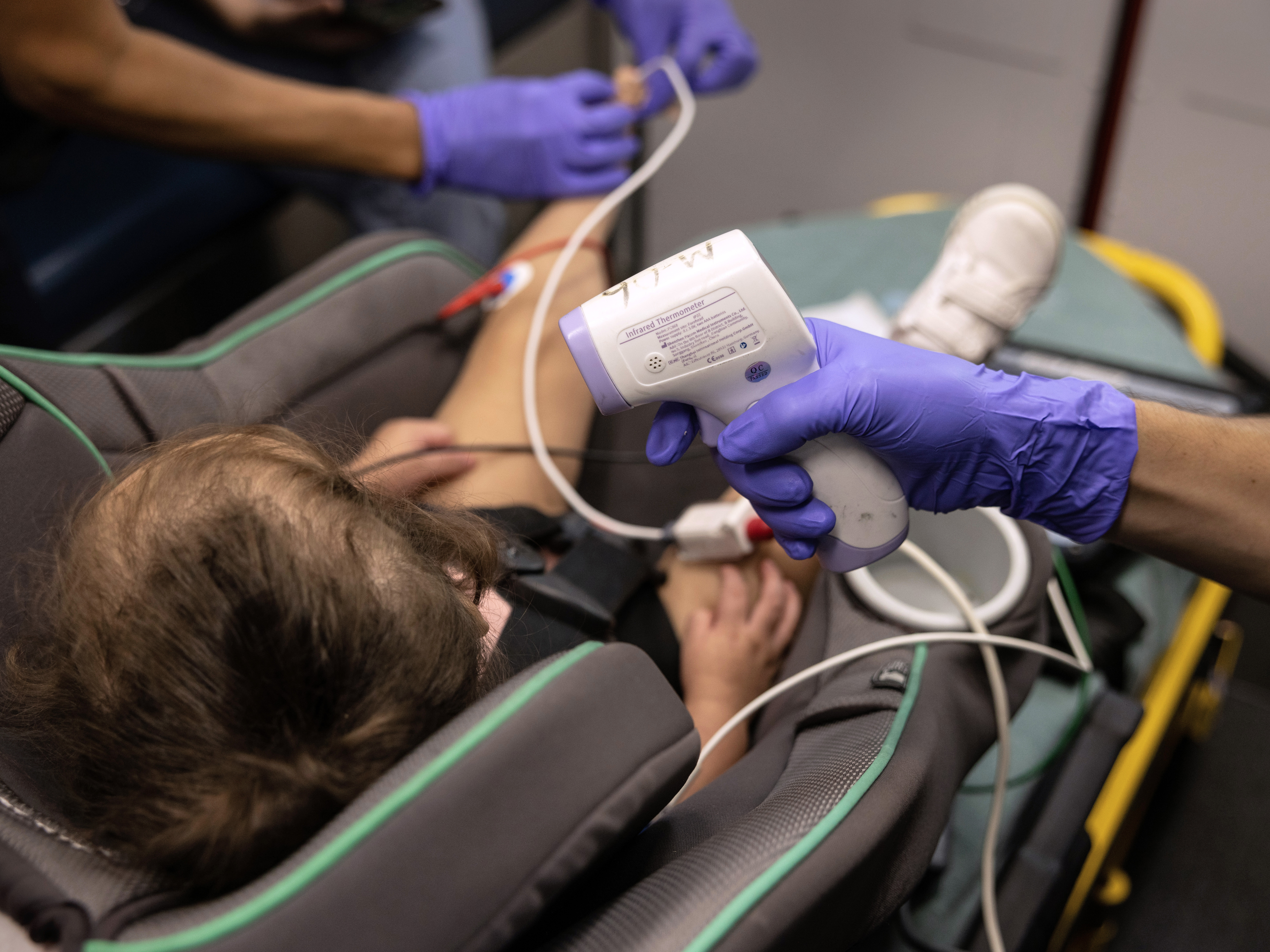 caption: EMS medics from the Houston Fire Department prepare to transport a 2-year-old girl to a hospital on Aug. 25.