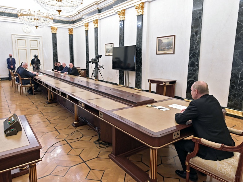 caption: Russian President Vladimir Putin chairs a meeting on economic issues at the Kremlin on Monday, as the ruble fell and his central bank raised its key rate to a historic high.