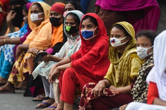 caption: Workers from the garment sector block a road during a protest to demand payment of due wages, in Dhaka, Bangladesh, in April 2020. They claimed that factories had not paid them after retailers and brands cancelled orders due to worldwide lockdown measures.