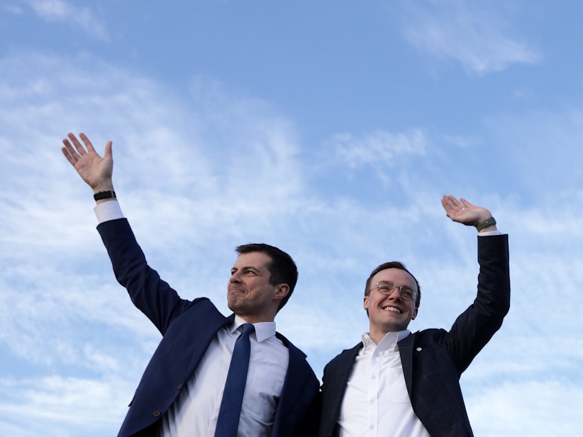 caption: Pete Buttigieg (left), now the secretary of transportation, appears alongside his husband, Chasten, in February 2020. The couple are now the parents of two children.