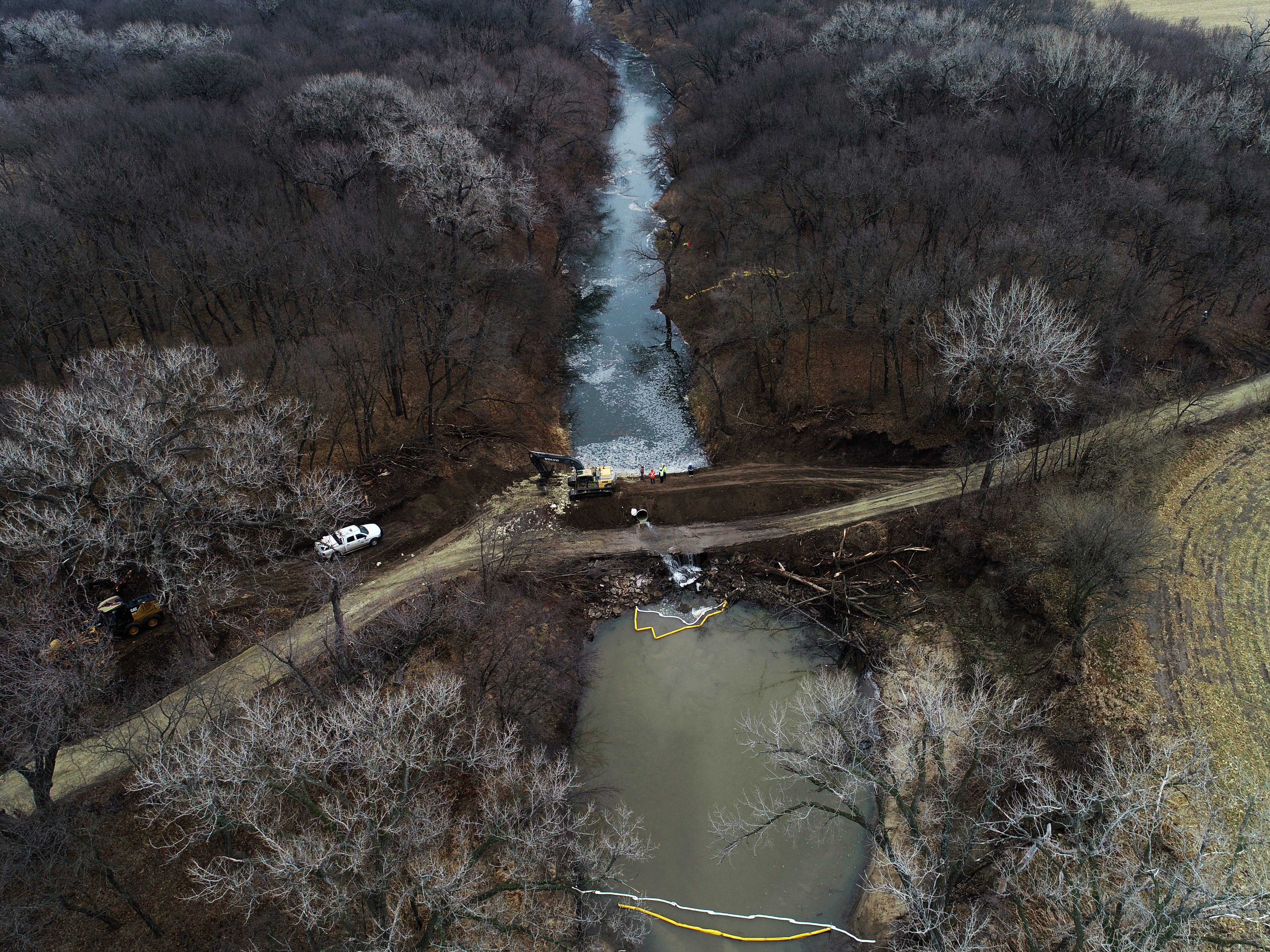 caption: In this photo taken by a drone, cleanup continues in the area where the ruptured Keystone pipeline dumped oil into a creek in Washington County, Kan., on Friday.