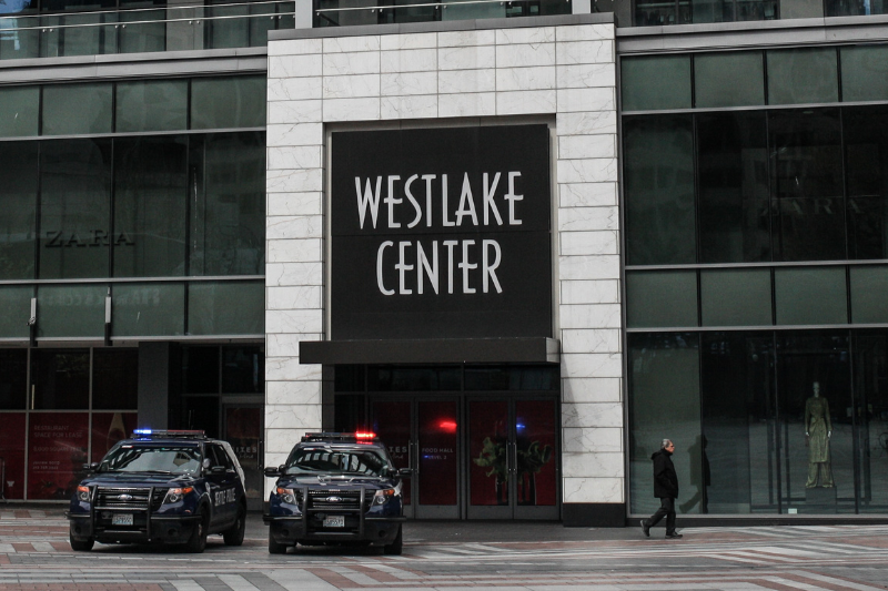 caption: Seattle police cars parked in front of Westlake Center. 