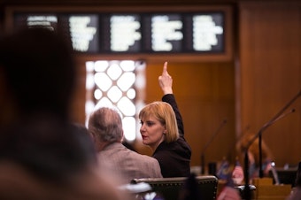 caption: House Majority Leader Jennifer Williamson, D-Portland, signals her vote on the House floor at the Capitol in Salem, Ore., Tuesday, April 2, 2019.