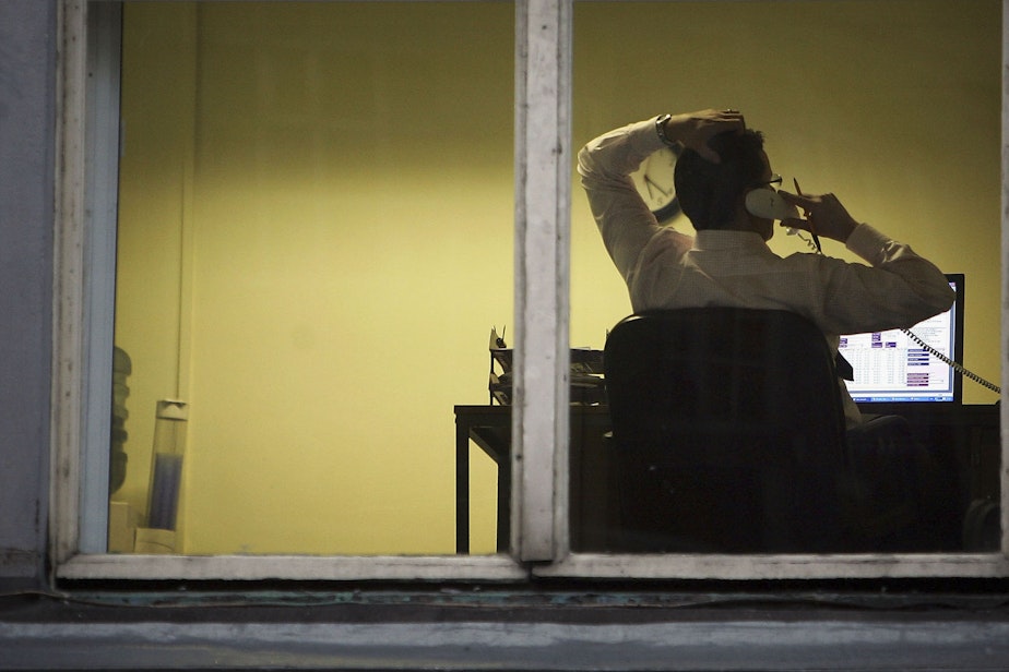 caption: A city office employee works into the night as darkness closes in on October 10, 2005 in Glasgow, Scotland. (Christopher Furlong/Getty Images)
