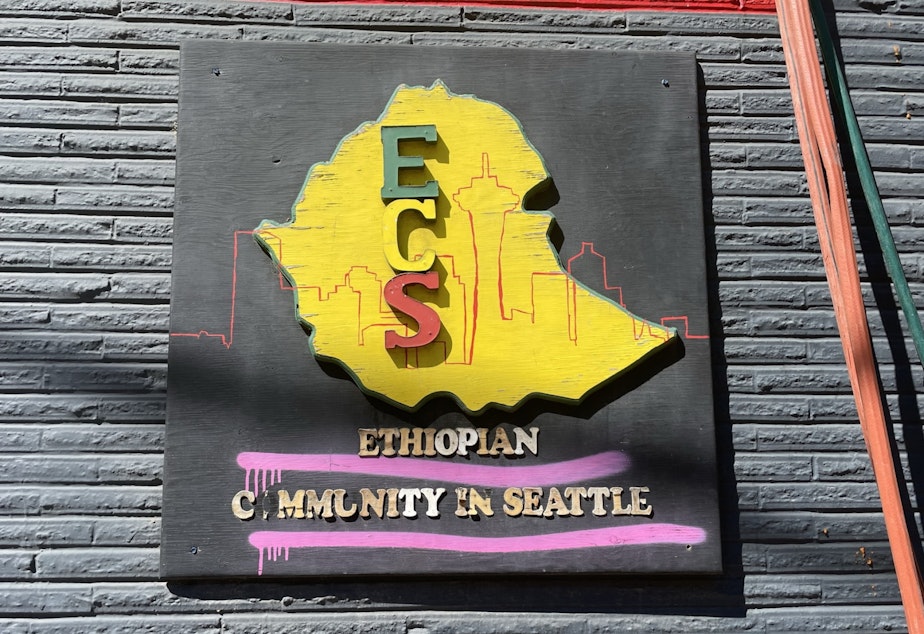 caption: A sign on an older building advertises the organization Ethiopian Community in Seattle
