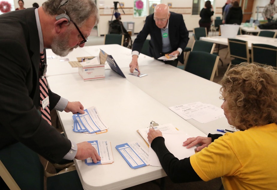 Presidential preference cards are counted at a caucus at West Des Moines Christian Church in Iowa on Monday. Problems with a smartphone app designed to report the caucus results ended up delaying an official count.