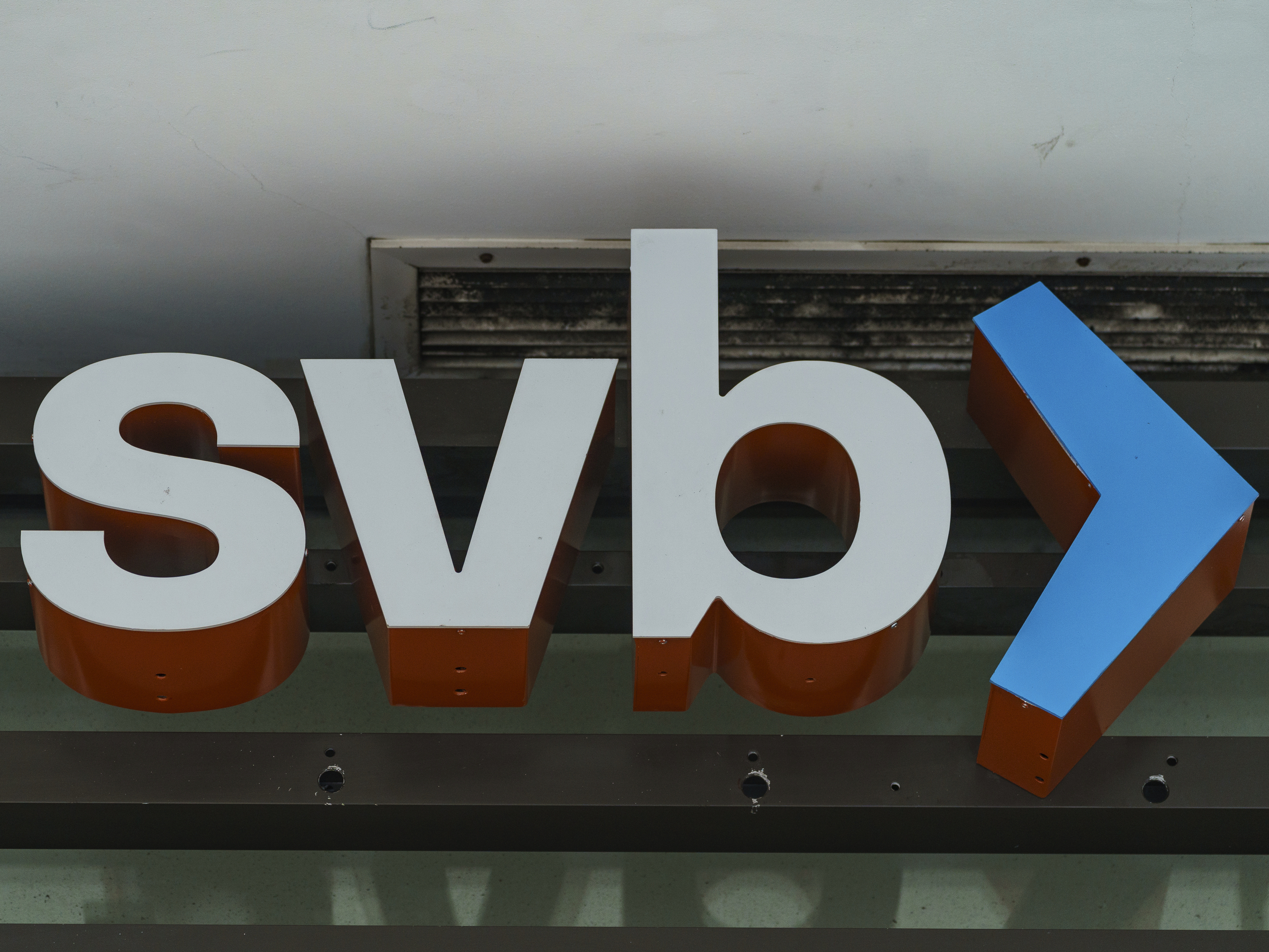 caption: The Silicon Valley Bank logo is seen at an open branch in Pasadena, Calif., on March 13, 2023.