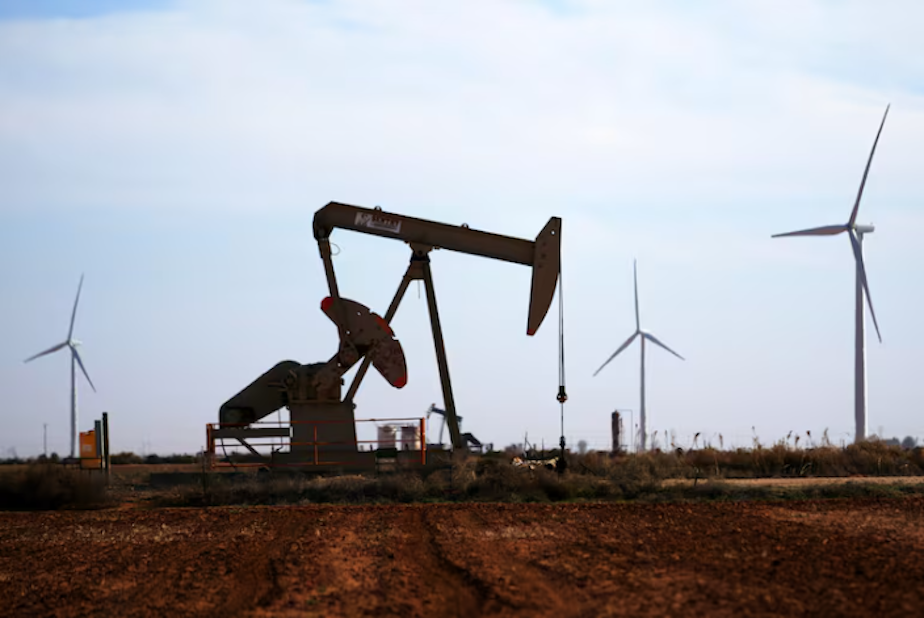 caption: Wind turbines behind a pumpjack on Wednesday, Feb. 26, 2025, in Lamesa, Texas. The state is an oil and gas powerhouse, but has also become the nation's biggest producer of wind and solar energy.