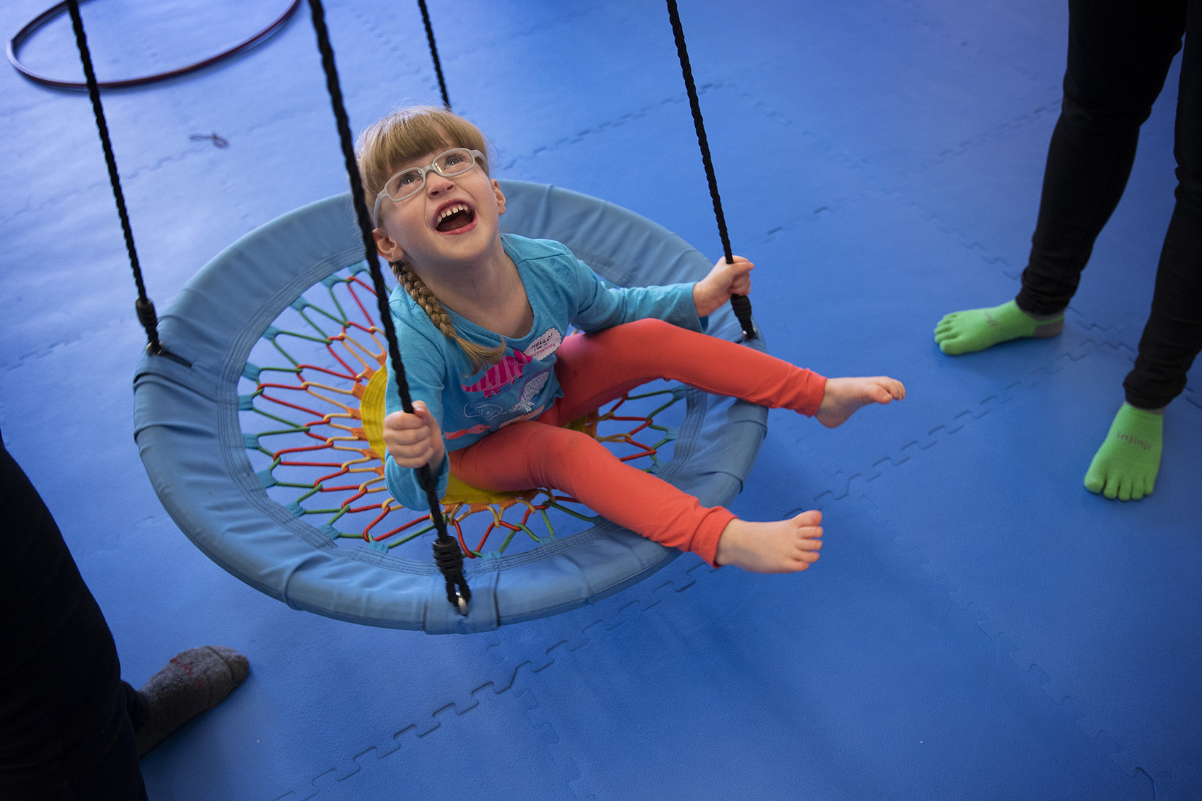 caption: Lillian Rockett, 4, laughs as she is pushed on a circular swing on Sunday, October 1, 2017, at We Rock the Spectrum Kid's Gym in Bellevue. 