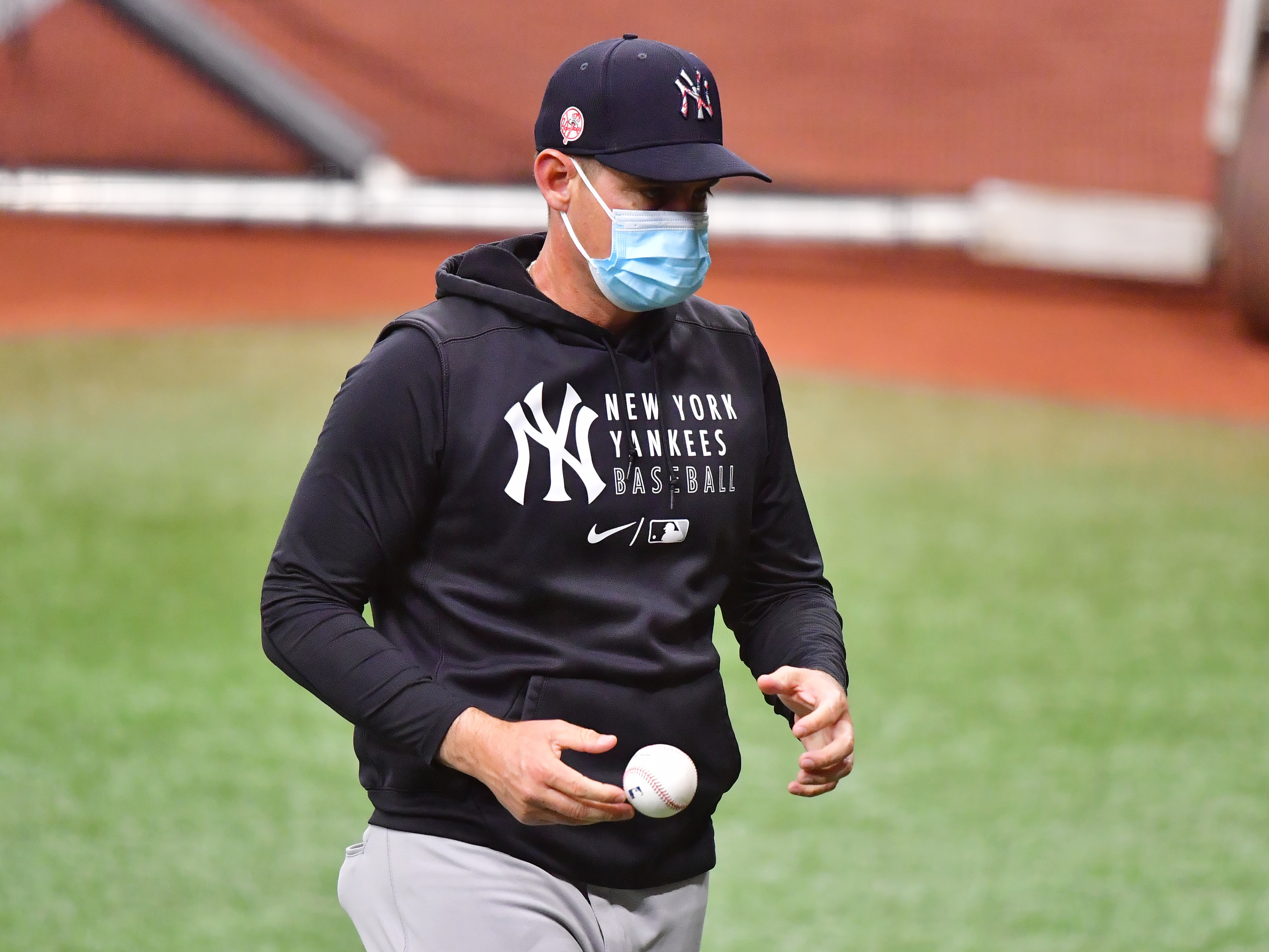 caption: The New York Yankees, including manager Aaron Boone, are back to wearing masks after the team reported eight "breakthrough" COVID-19 infections this week.
