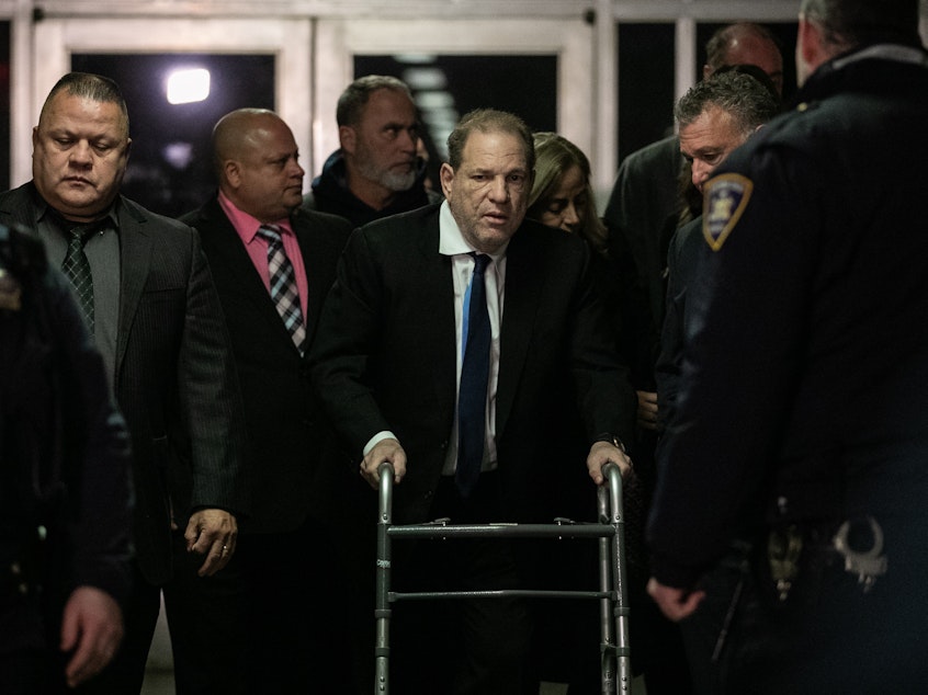 caption: Harvey Weinstein (center) leaves a bail hearing last month in New York City. The former Hollywood megaproducer has been accused of sexual misconduct by dozens of women. He now faces five charges in New York City.