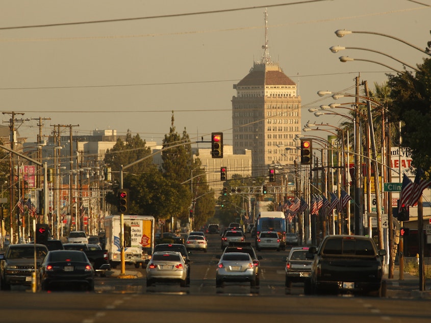 caption: Traffic on a hazy evening in Fresno, Calif. A new study estimates that about 50,000 lives could be saved each year if the U.S. eliminated small particles of pollution that are released from the tailpipes of cars and trucks, among other sources.