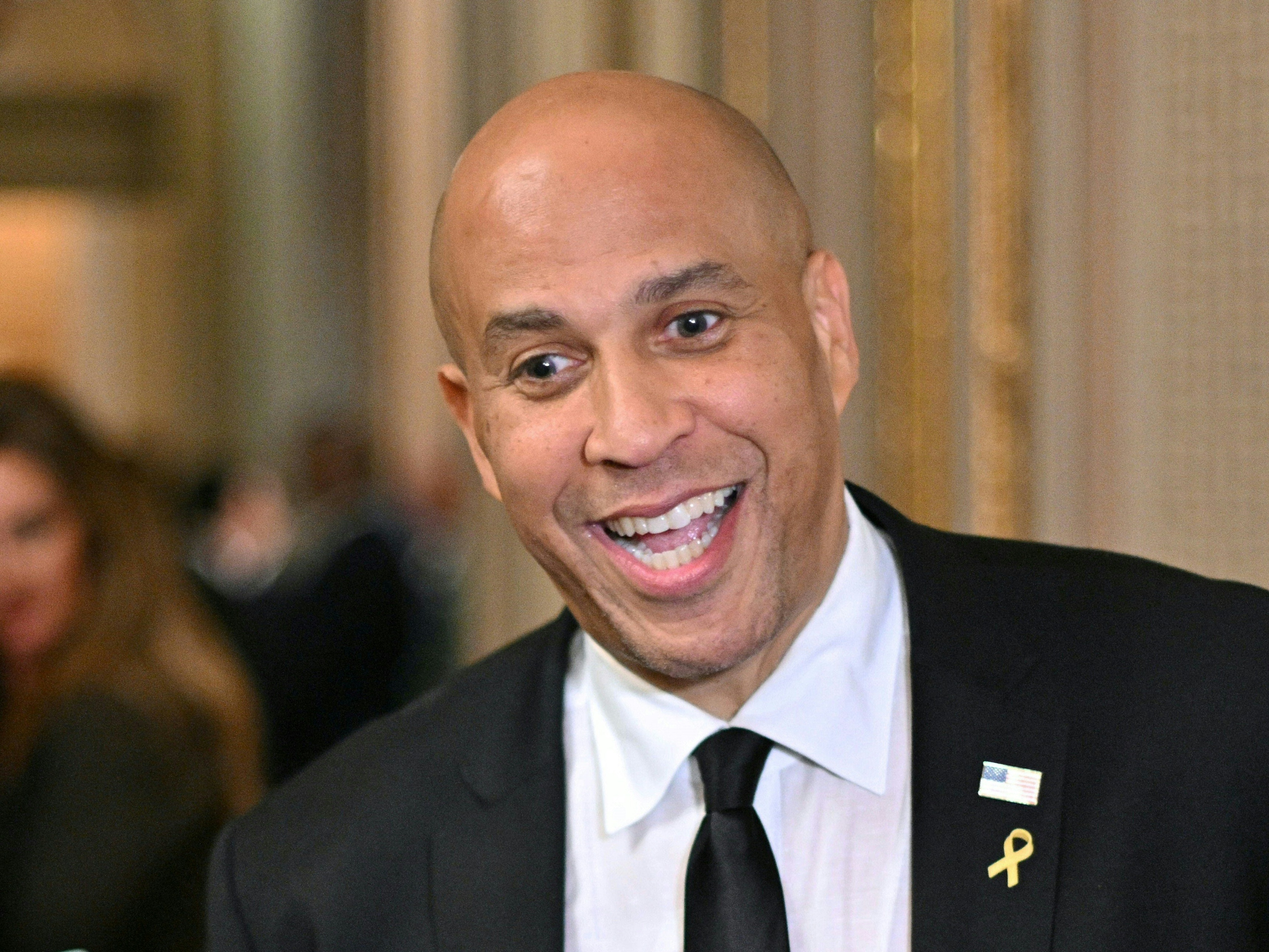 caption: Sen. Cory Booker (D-NJ) speaks to the press at the U.S. Capitol in Washington on Wednesday. Booker spoke for more than 25 hours against President Trump's "unconstitutional" actions.