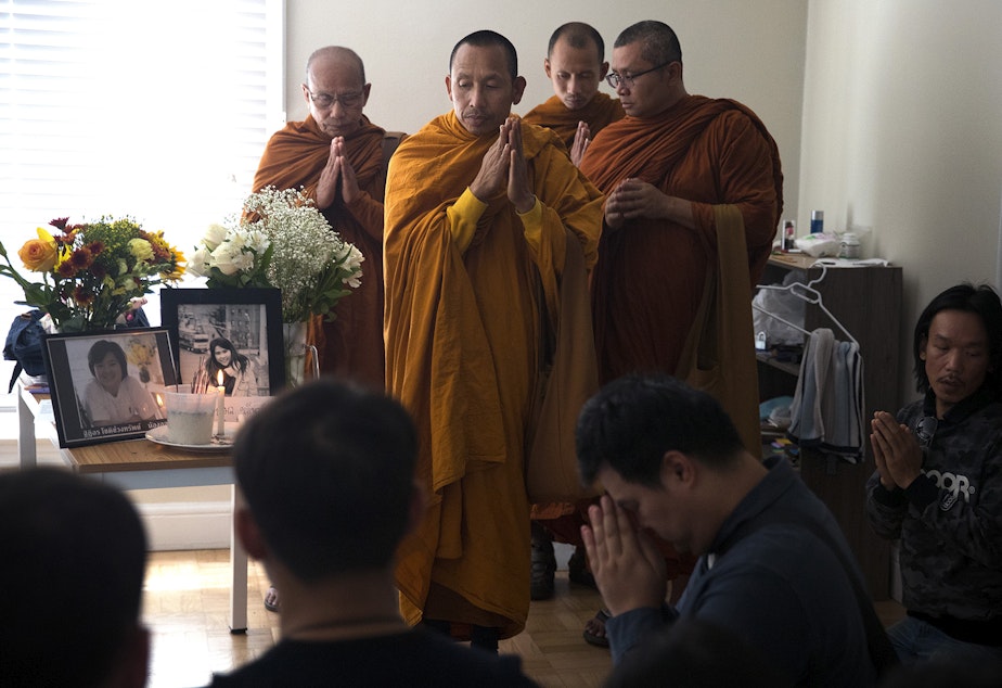 caption: A dedication ceremony with the Buddhangkura Buddhist Temple of Washington takes place in the apartment of Kornkamon Leenawarat, 25, and Thiti-on Chotechuangsab, 32, on Wednesday, September 12, 2018, at the Malloy Apartments in Seattle.