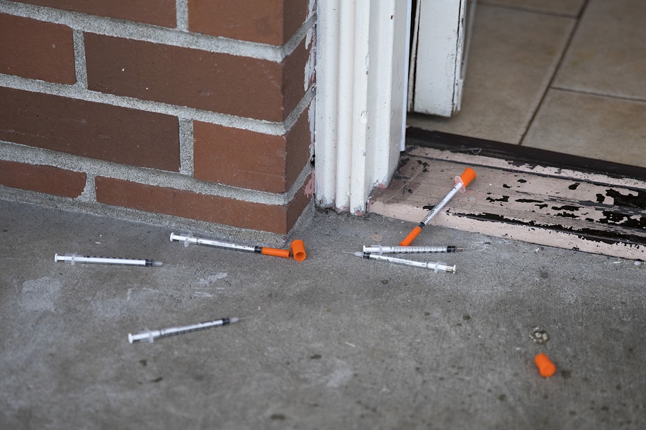 caption: Needles are shown in the doorway of a room at Sun Hill Motel on Wednesday, March 21, 2018, on Aurora Avenue North in Seattle. 