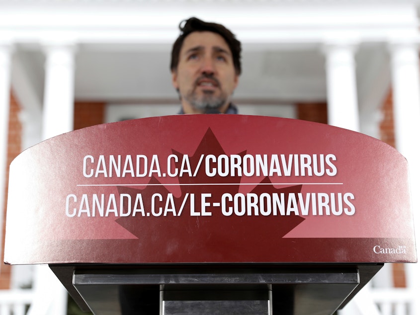 caption: Canada's Prime Minister Justin Trudeau attends a news conference to discuss efforts to slow the spread of the coronavirus, in Ottawa, Ontario, on Monday.