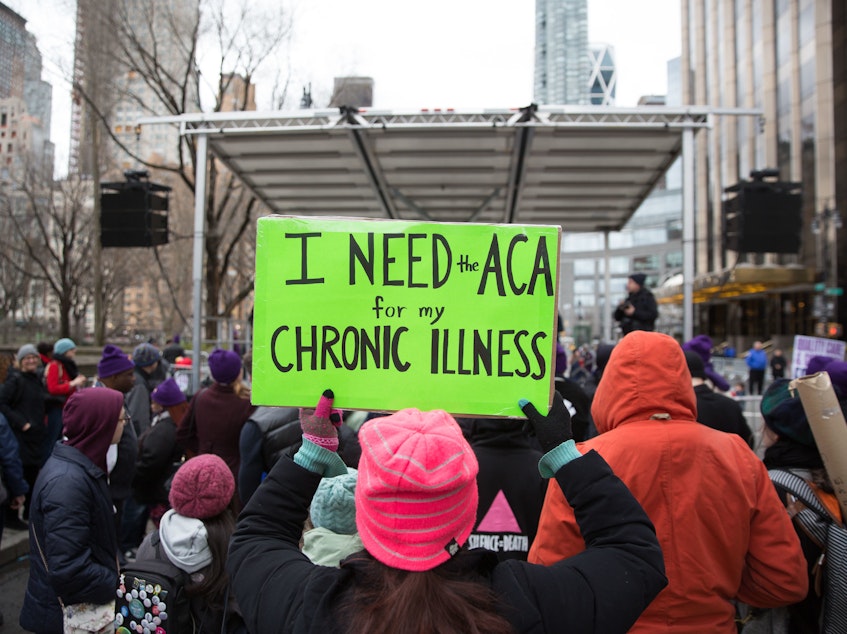 caption: The Justice Department sent a letter in support of repealing the entirety of the Affordable Care Act. Here, a sign in support of the ACA in April 2017 in New York City.