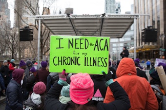 caption: The Justice Department sent a letter in support of repealing the entirety of the Affordable Care Act. Here, a sign in support of the ACA in April 2017 in New York City.