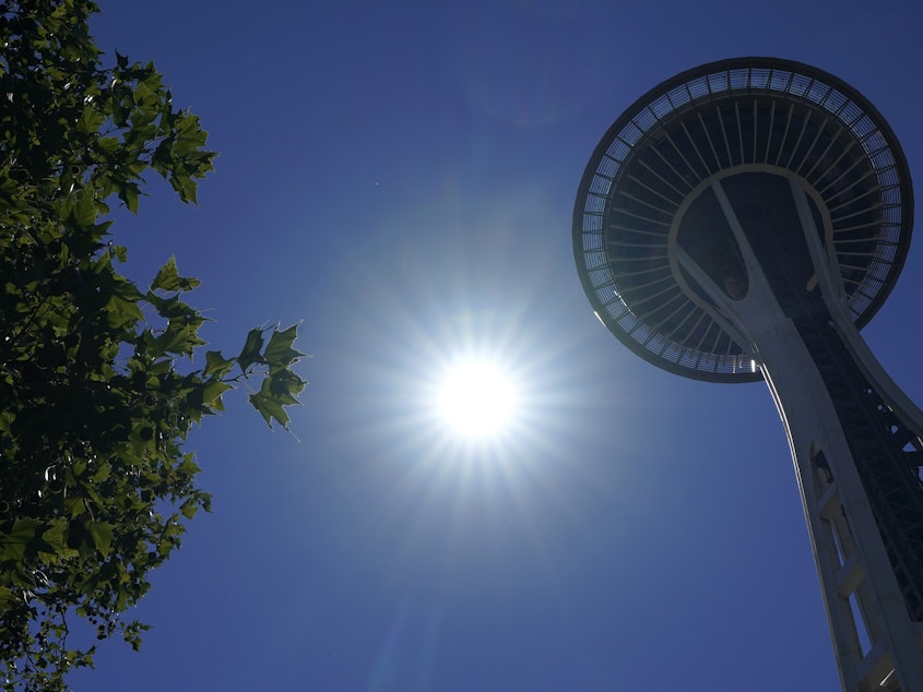 caption: The sun shines near the Space Needle, Monday, June 28, 2021, in Seattle.