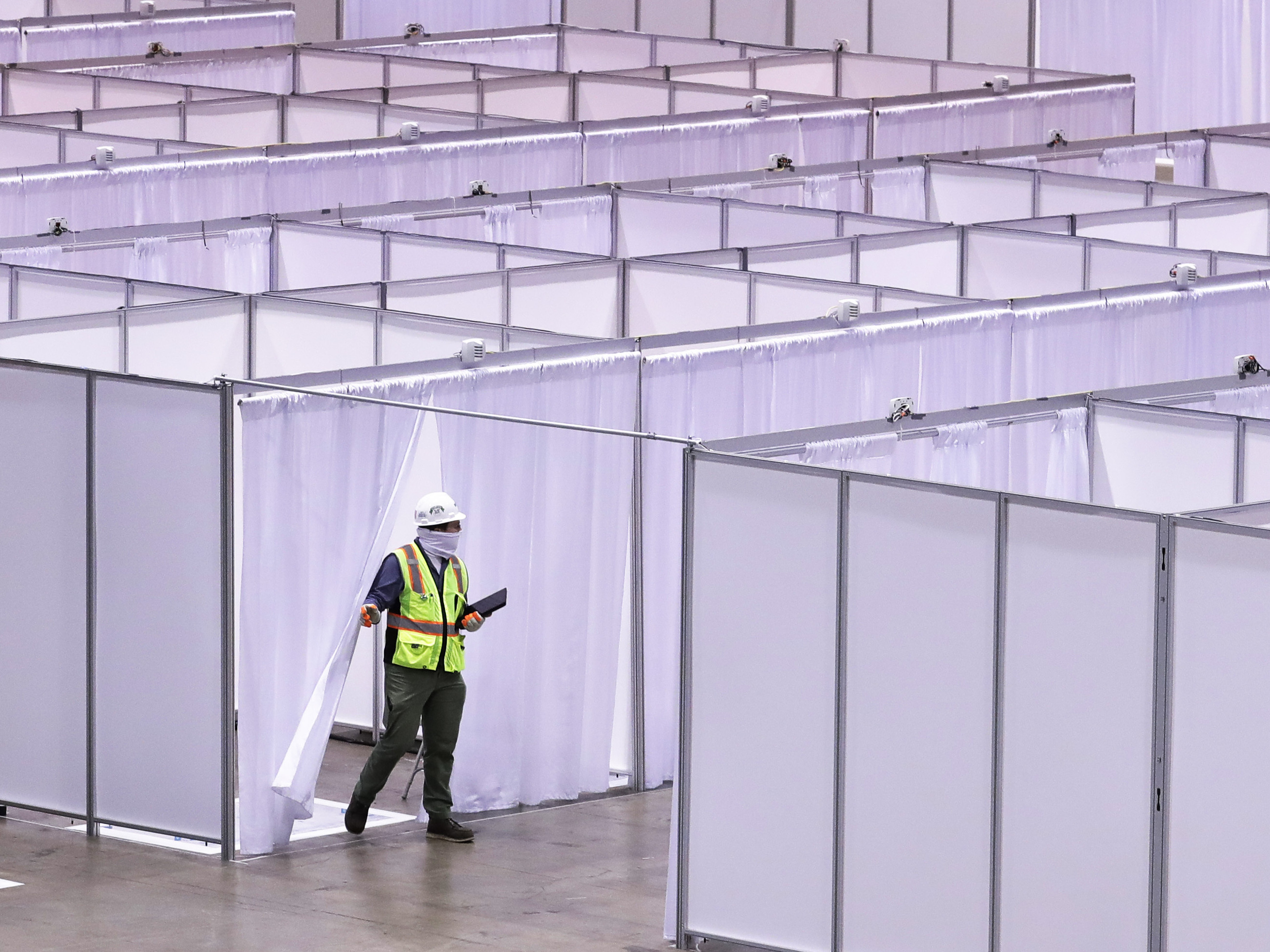 caption: Construction at the COVID-19 field hospital at McCormick Place in Chicago on April 10. The city pared back plans for a 3,000-bed temporary hospital at the nation's largest convention center as infection numbers decreased.