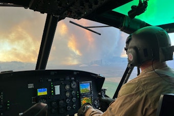 caption: A Spokane County Sheriff's Office helicopter pilot flies near the Medical Lake fire on Friday, Aug. 18, 2023.