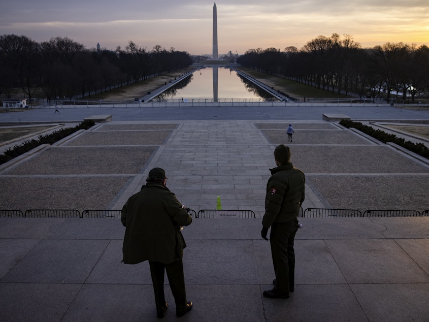 caption: U.S. park rangers look at the spot where Rev. Martin Luther King Jr. gave his famous "I Have a Dream" speech on the steps of the Lincoln Memorial in Washington, D.C., on Friday. Security threats have prompted officials to shut down the National Mall and much of downtown Washington, D.C.