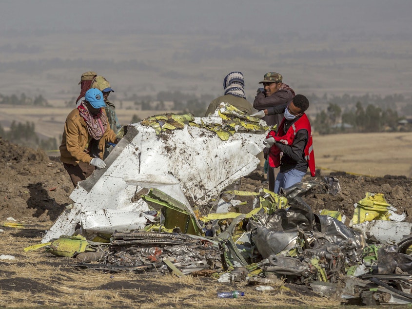caption: Rescuers work at the scene of the Ethiopian Airlines 737 Max crash south of Addis Ababa, Ethiopia last year.