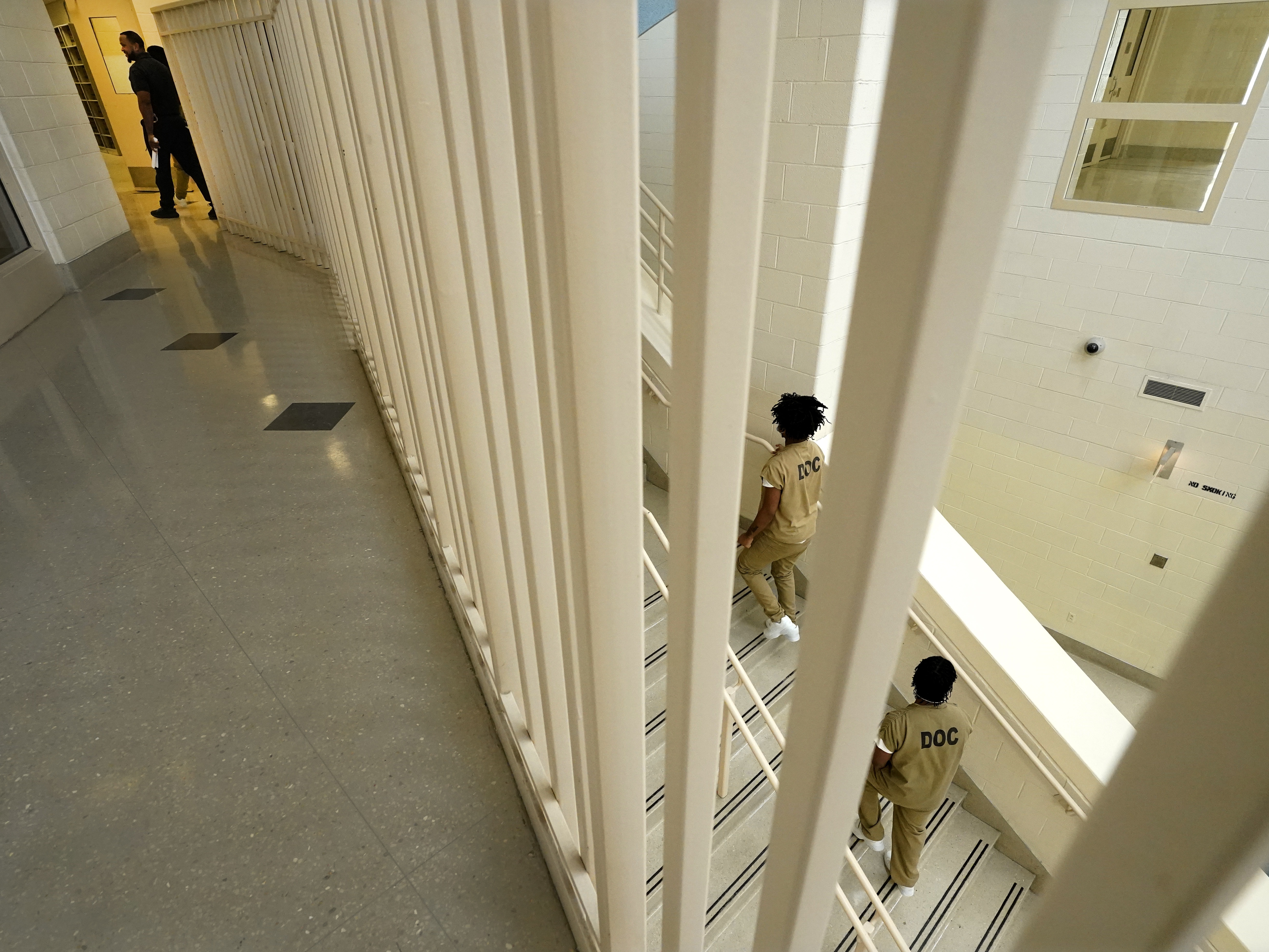 caption: Inmates at the Cook County, Ill., jail head to a staging area at the jail's Division 11 law library before registering and voting in the local election in 2023 in Chicago.