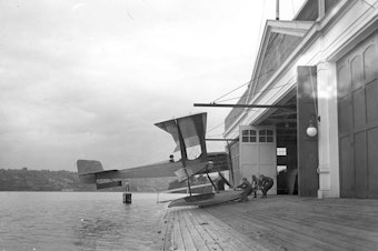 caption: The first Boeing airplane, the Bluebill, B&W Model 1, assembled and launched from Seattle's Lake Union