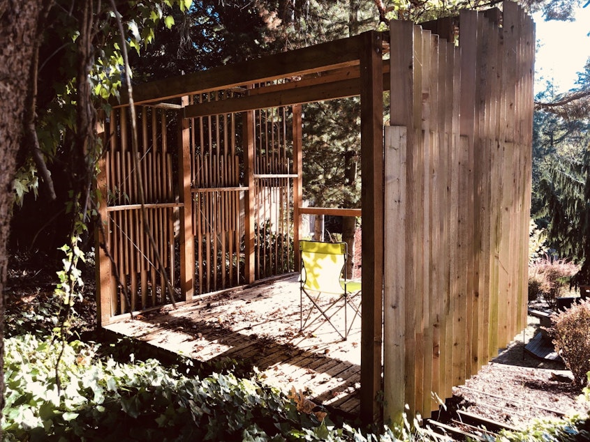 caption: Architect Ryan Mullenix spent part of the summer working in this treehouse in his yard.