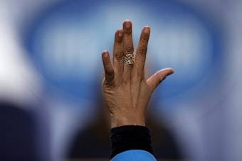caption: Reporter April Ryan raises her hand during a press briefing at the White House in 2017. Her pointed questioning has often earned her the ire of the Trump administration's communications team, as she writes in <em>Under Fire</em>.