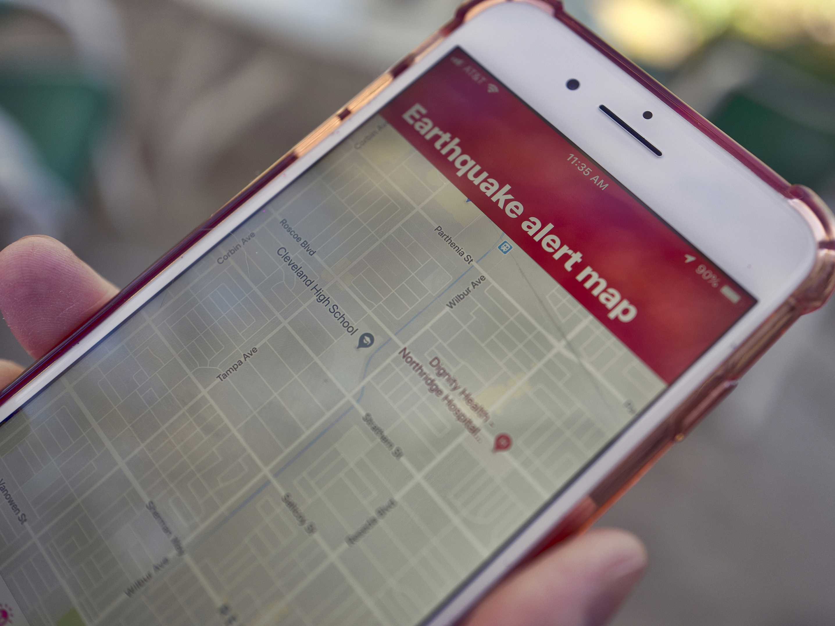 caption: A mobile phone customer in Los Angeles looks at an earthquake warning application on an iPhone. An earthquake early warning system operated by the U.S. Geological Survey has been activated in Oregon, California and now Washington.