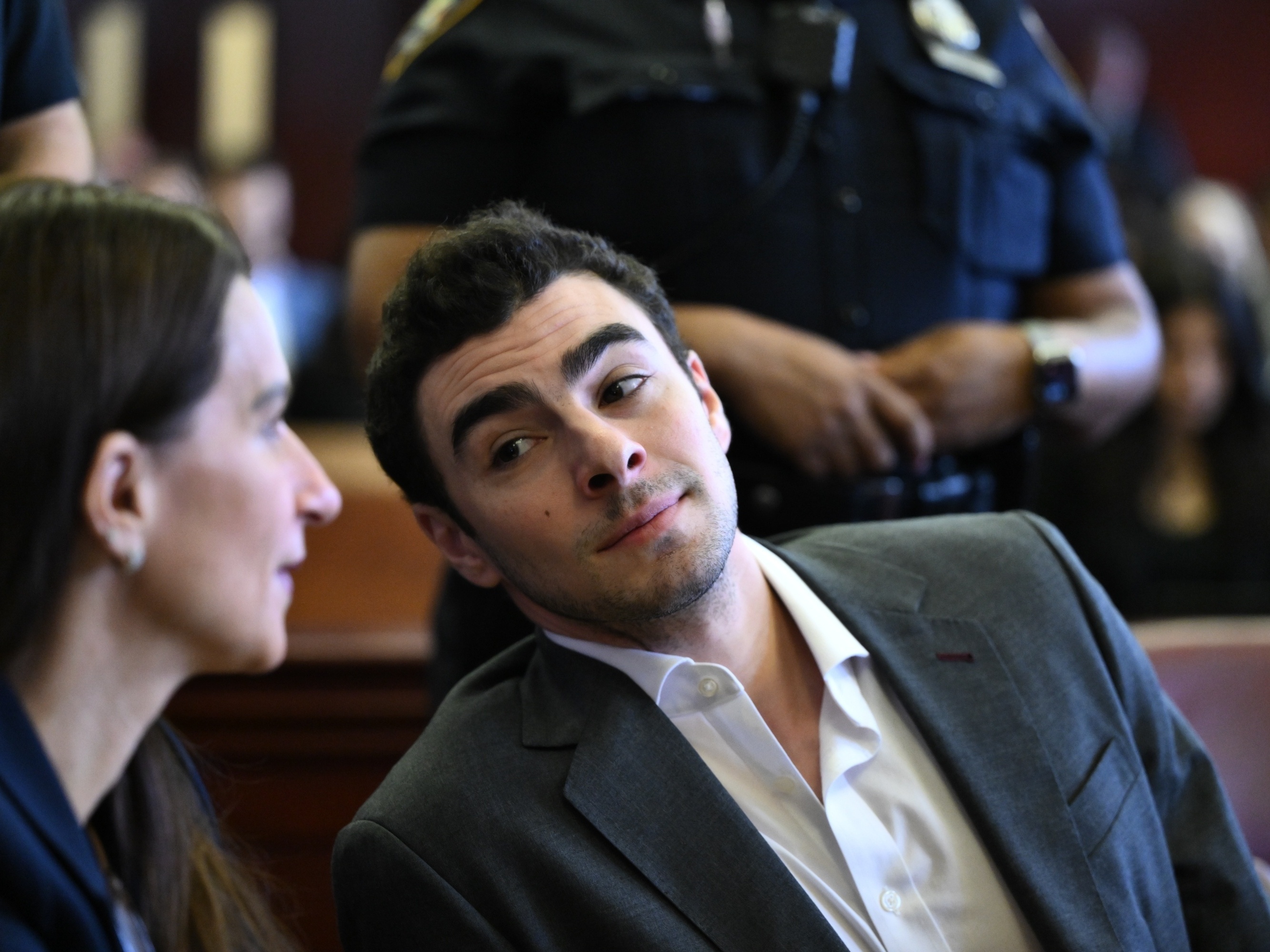 caption: Luigi Mangione appears in Manhattan Criminal Court for an evidence hearing on Thursday in New York.